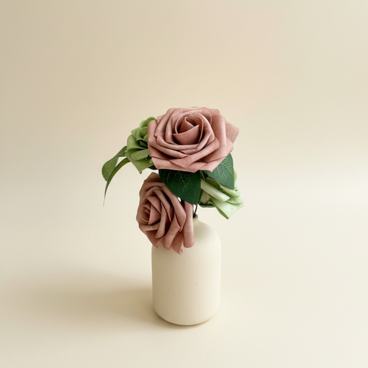 Dusty rose arrangement with cream background